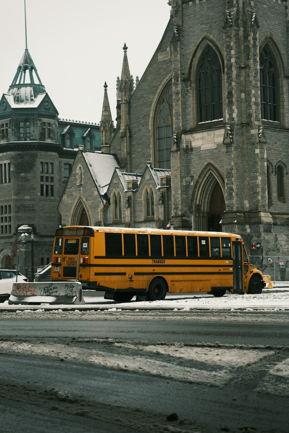 a yellow school bus parked in front of a church