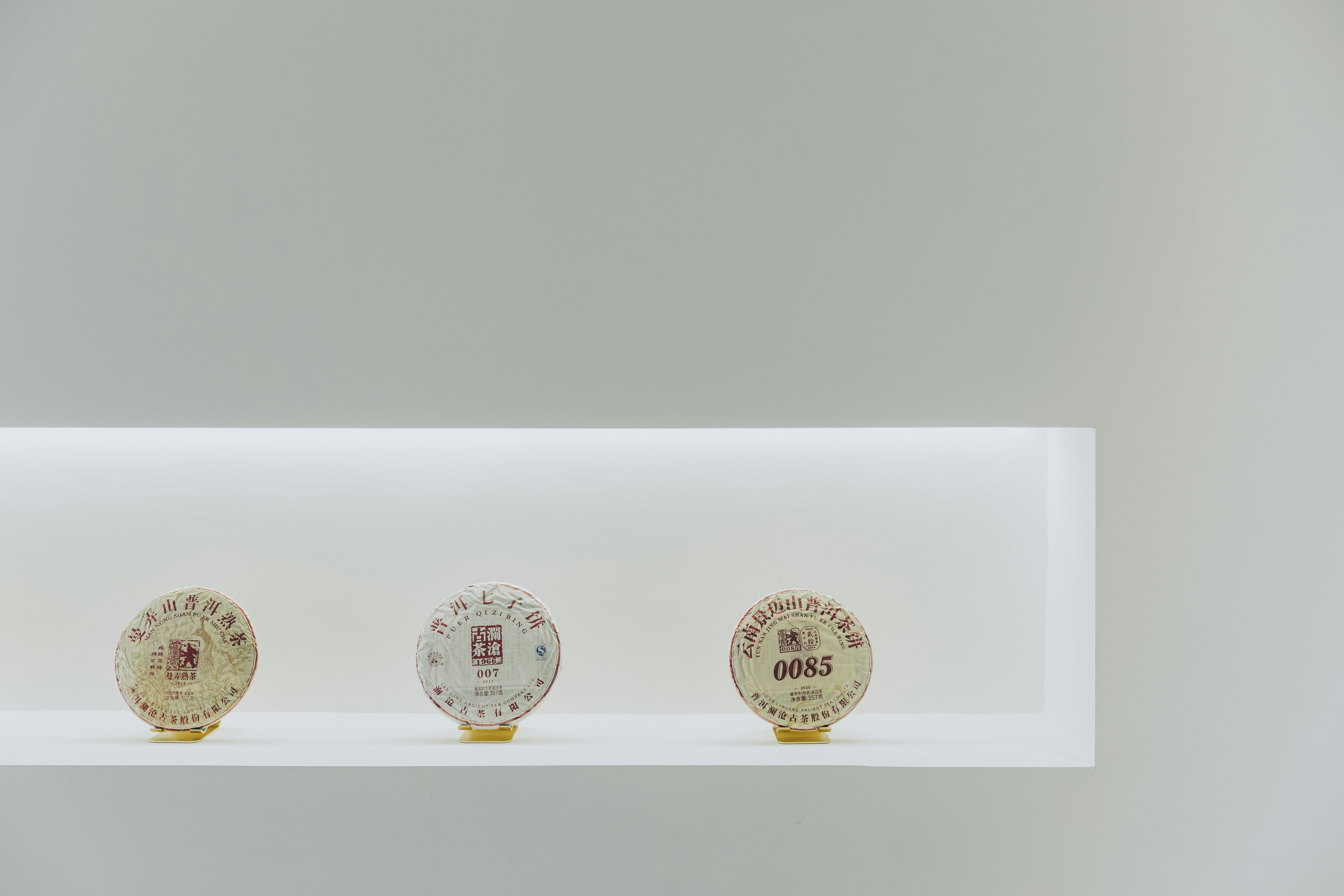three different types of clocks on a shelf