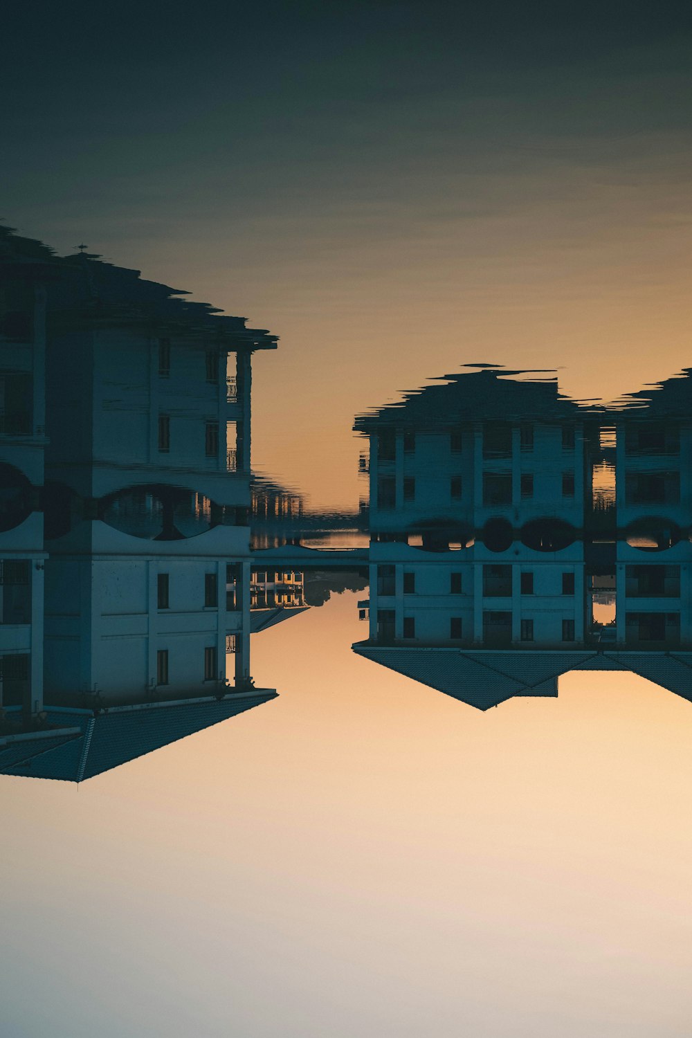 a reflection of a building in a body of water