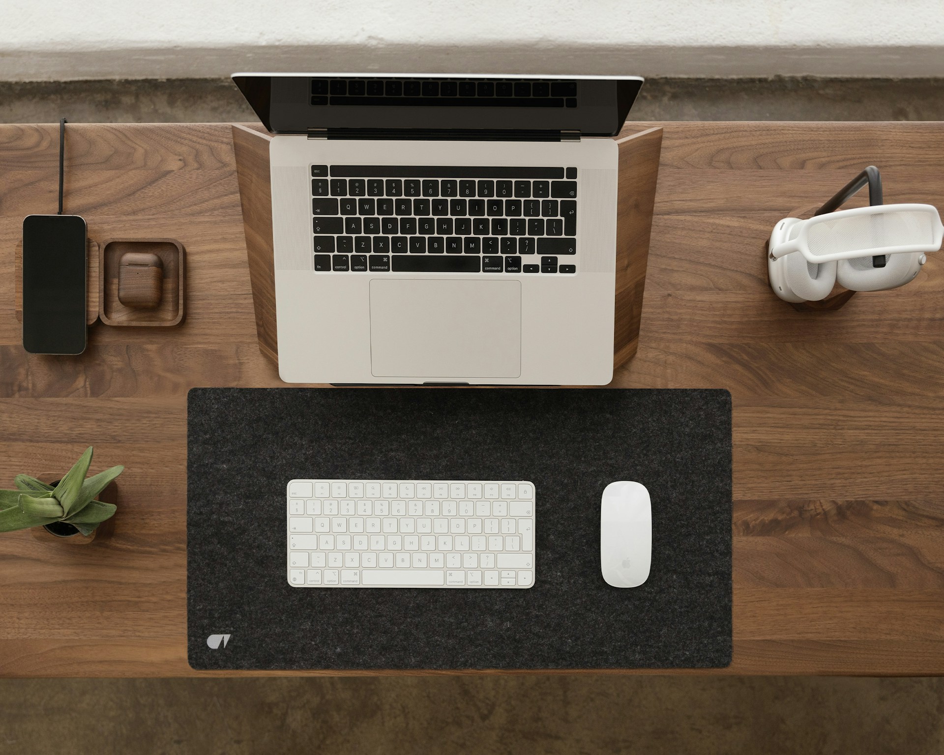 a laptop computer sitting on top of a wooden desk