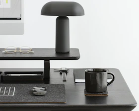Minimalist workspace setup with sleek black and cobalt blue accents, showcasing organized desk accessories.