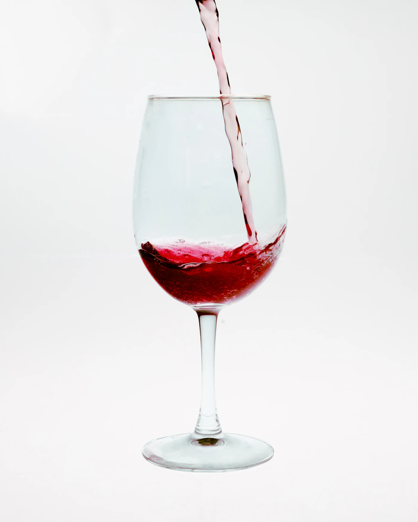 Rotwein wird ins Glas eingeschenkt