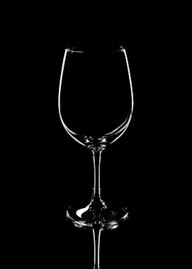 a black and white photo of a wine glass