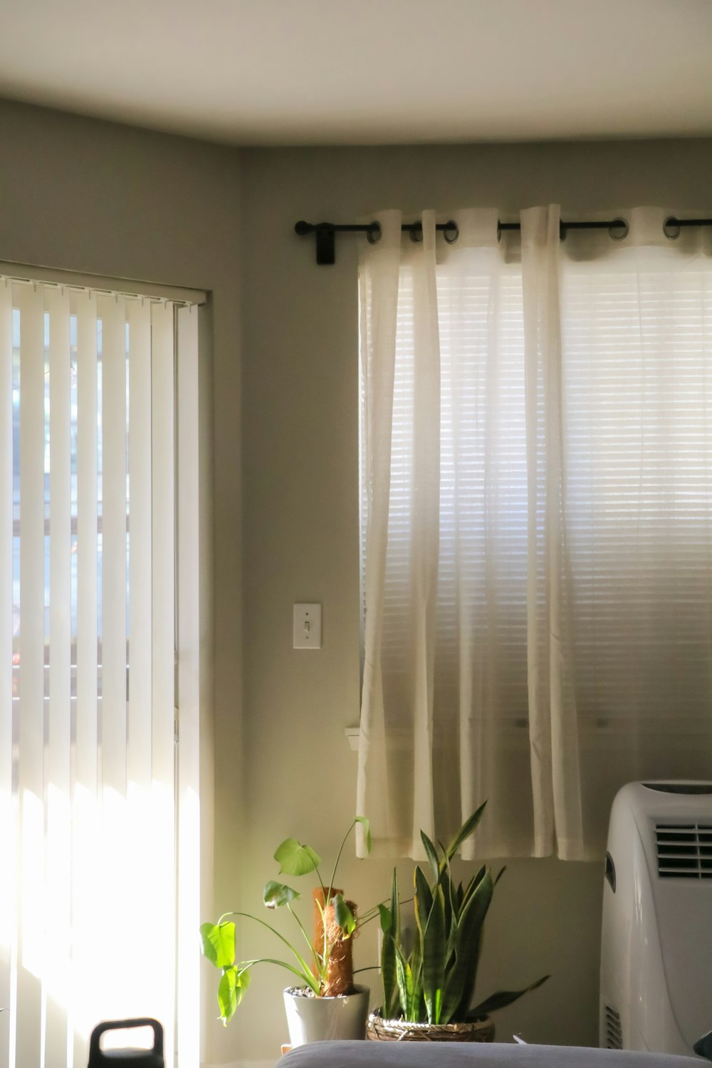 a living room with a window and a air conditioner