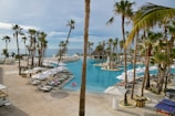 a beach resort with a pool and palm trees