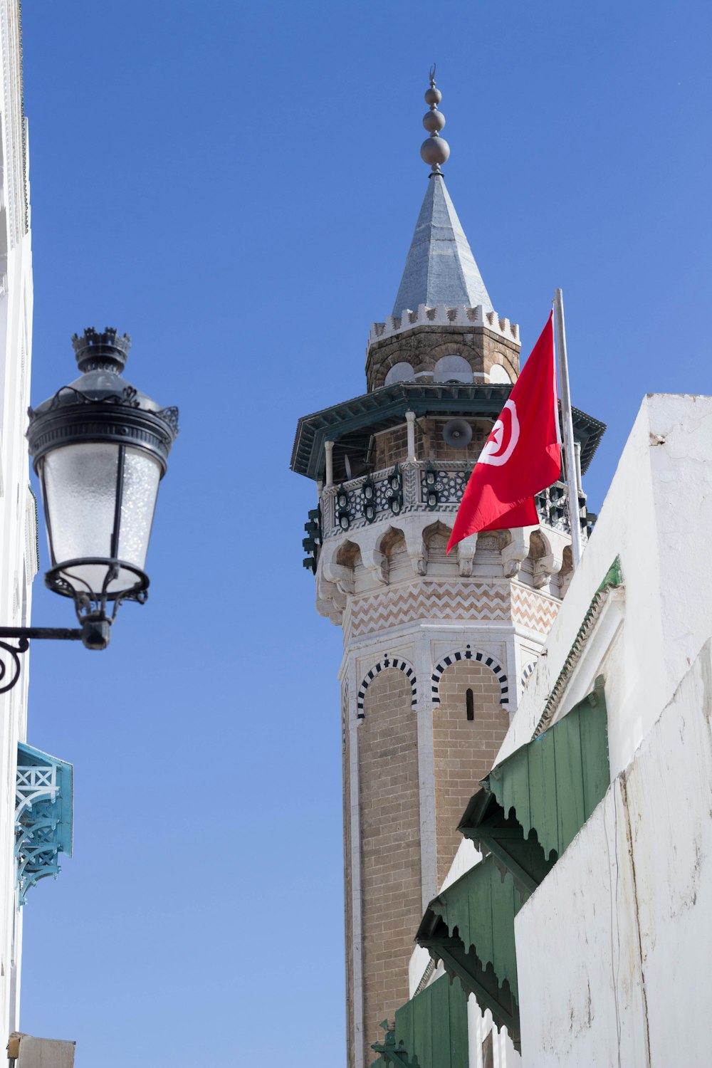 a tall tower with a flag on top of it