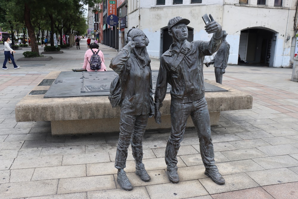 a statue of two people standing next to each other