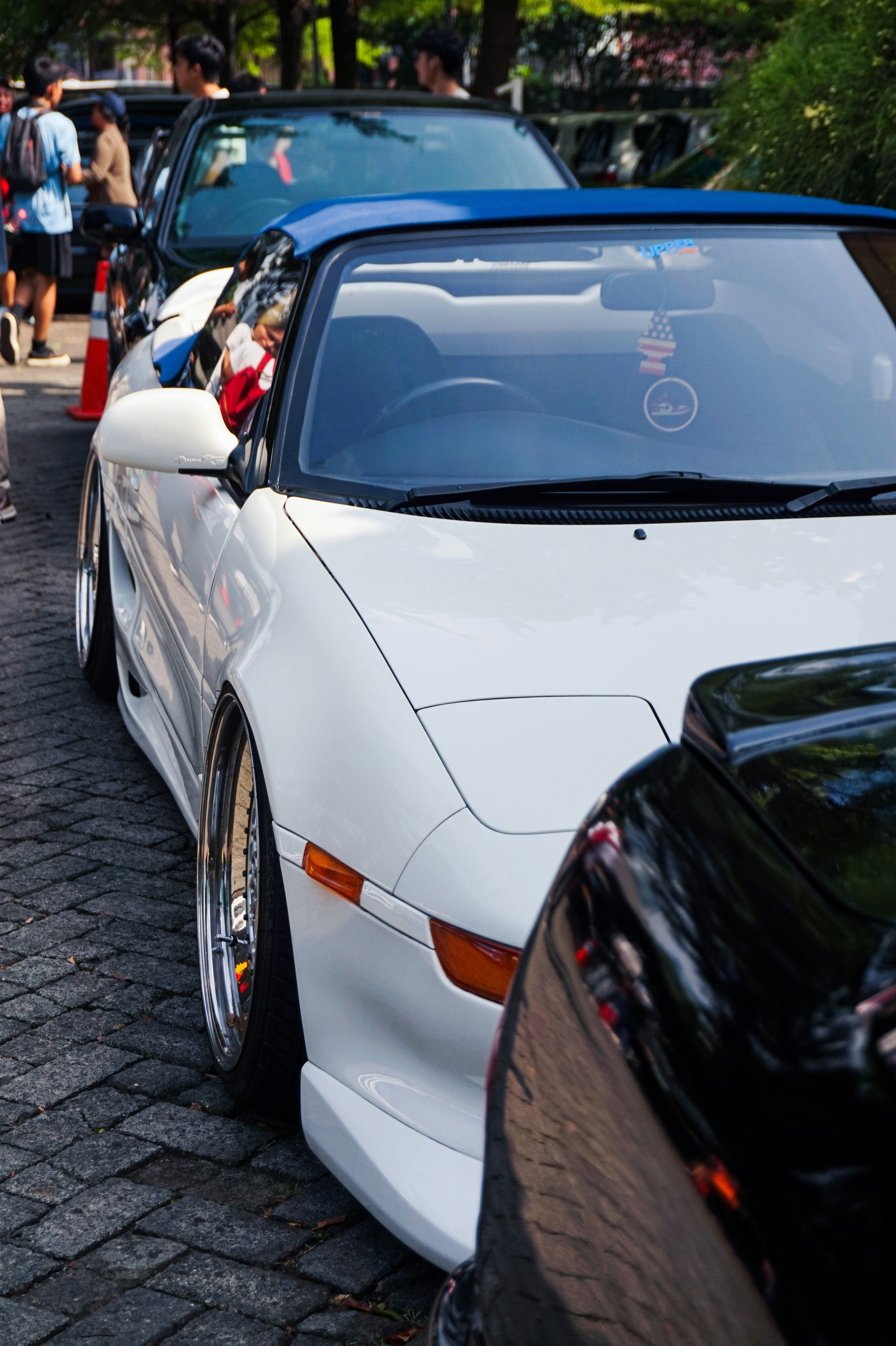 a group of cars parked next to each other on a street