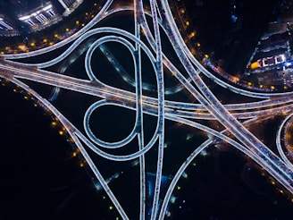 an aerial view of a highway intersection at night