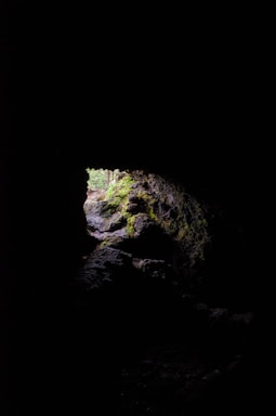 a dark cave with a light at the end
