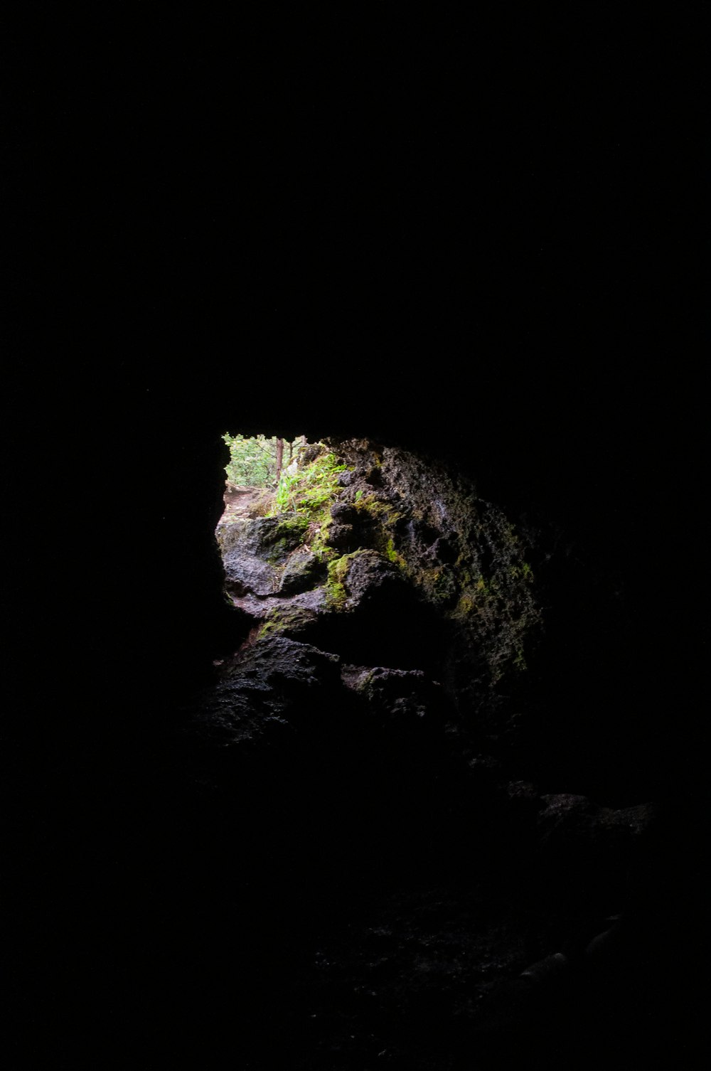 a dark cave with a light at the end