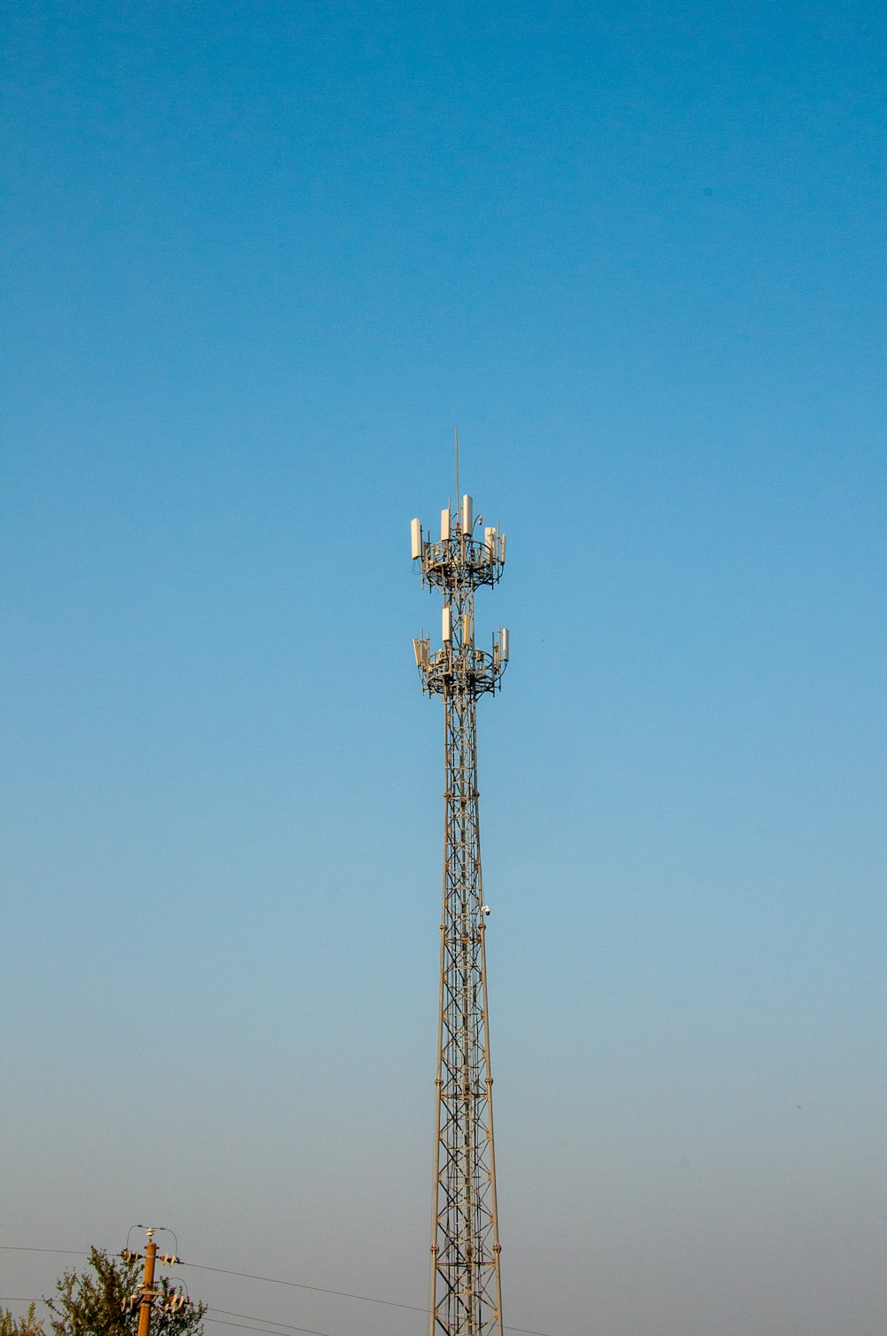 a tall tower with a cell phone on top of it