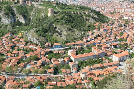 A vibrant orange and white themed map highlighting prime Pune localities with available plots.