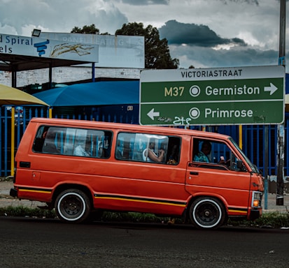 A friendly Flowfix plumber answering a call beside a van with tools in Cape Town.