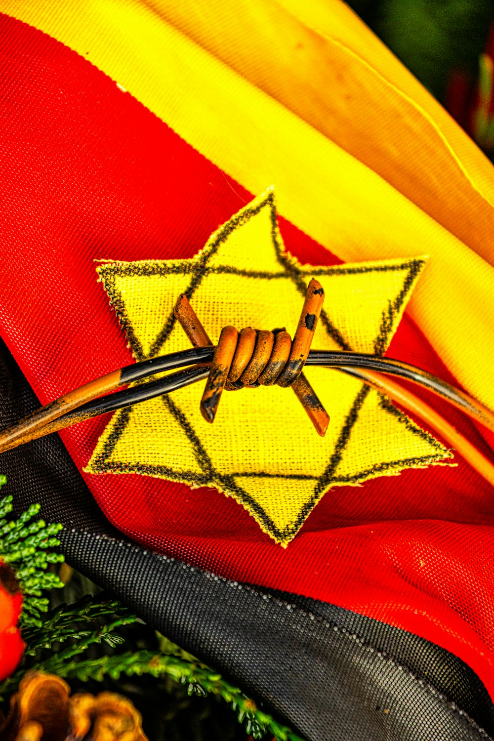a red and yellow umbrella with a yellow star on it