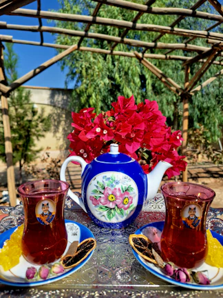 A beautifully arranged tea service with traditional Moroccan teapots and glasses.