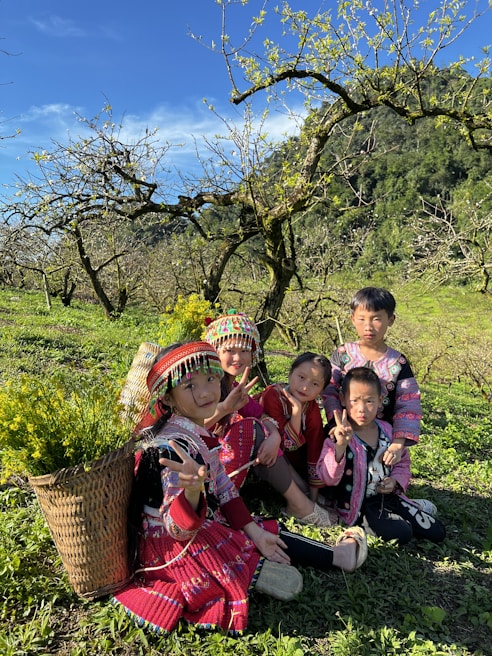 Children dressed in colorful Divine Lioness apparel playing together on a bright, breezy day.