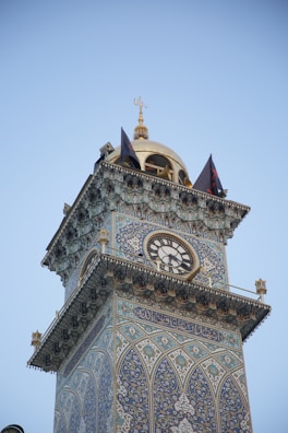 Close-up of a beautifully crafted Islamic clock showing prayer times