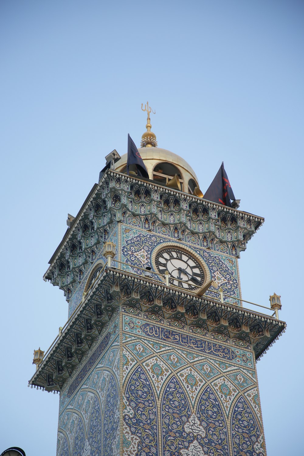 a tall clock tower with a clock on each of it's sides