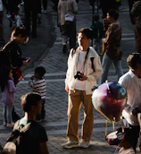 Steven filming a vibrant street scene with natural light.