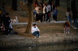 A group gathered around a pond, learning about bait selection and fish behavior.