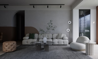a living room with a couch, chair, table and speakers