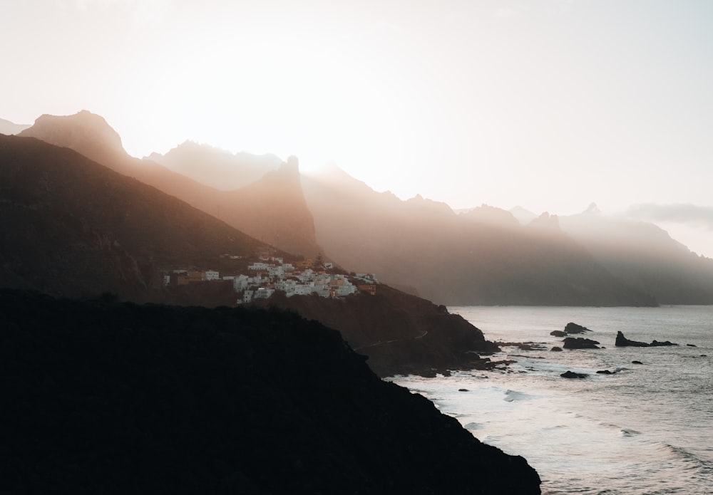 a view of a body of water with mountains in the background