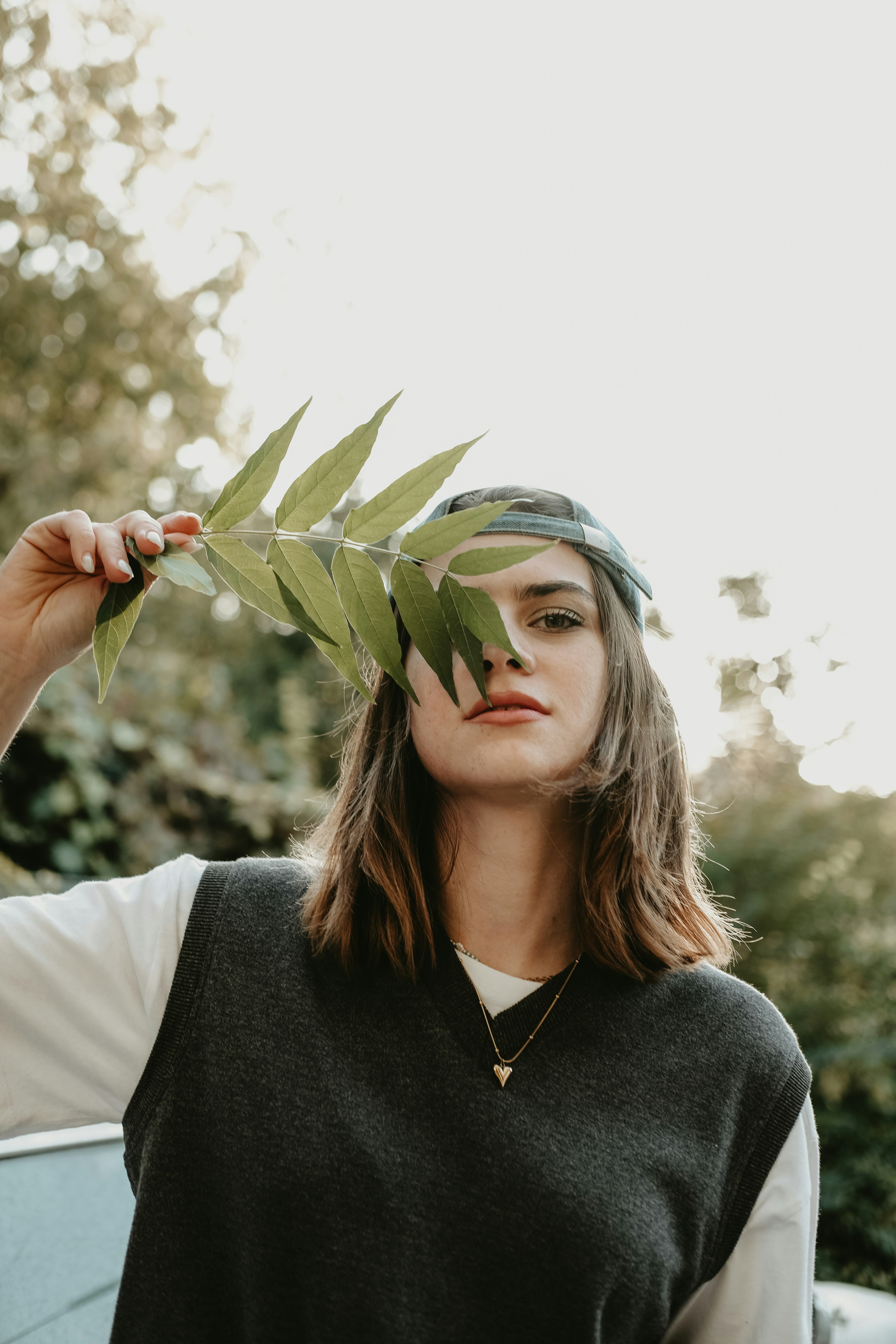 a woman holding a leaf over her head