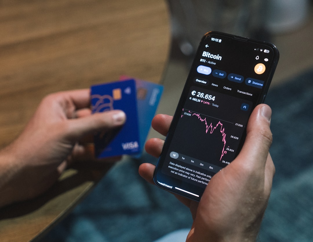 a person holding a cell phone in their hand, Crypto credit card