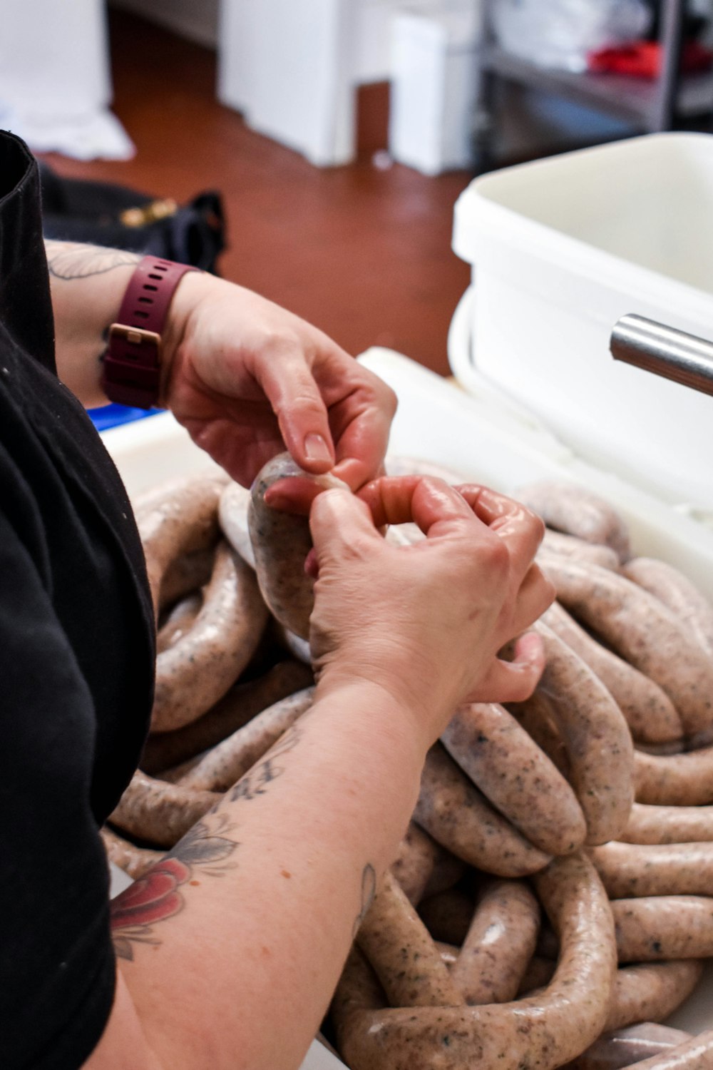 a person holding a sausage in their hands