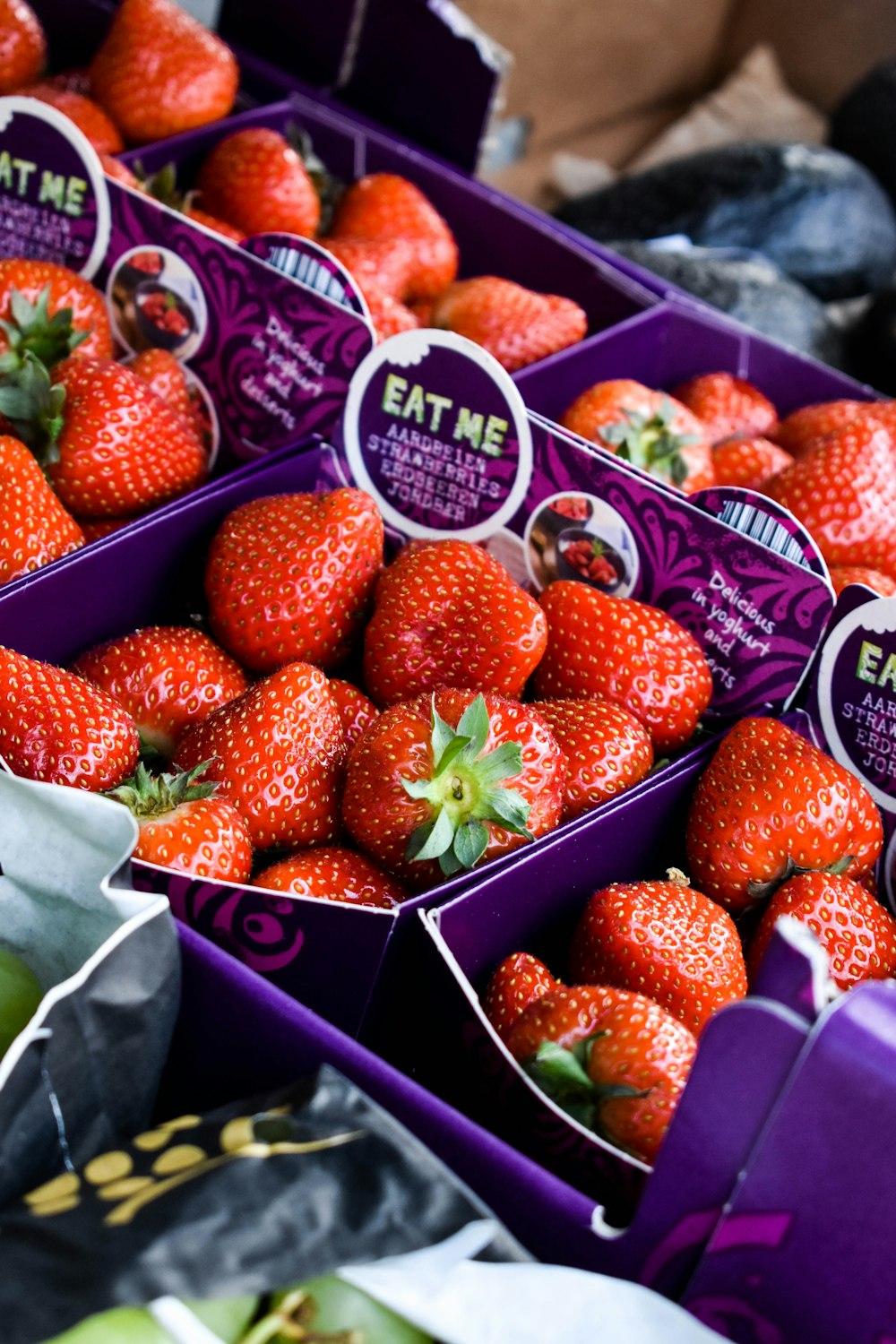 a close up of many boxes of strawberries