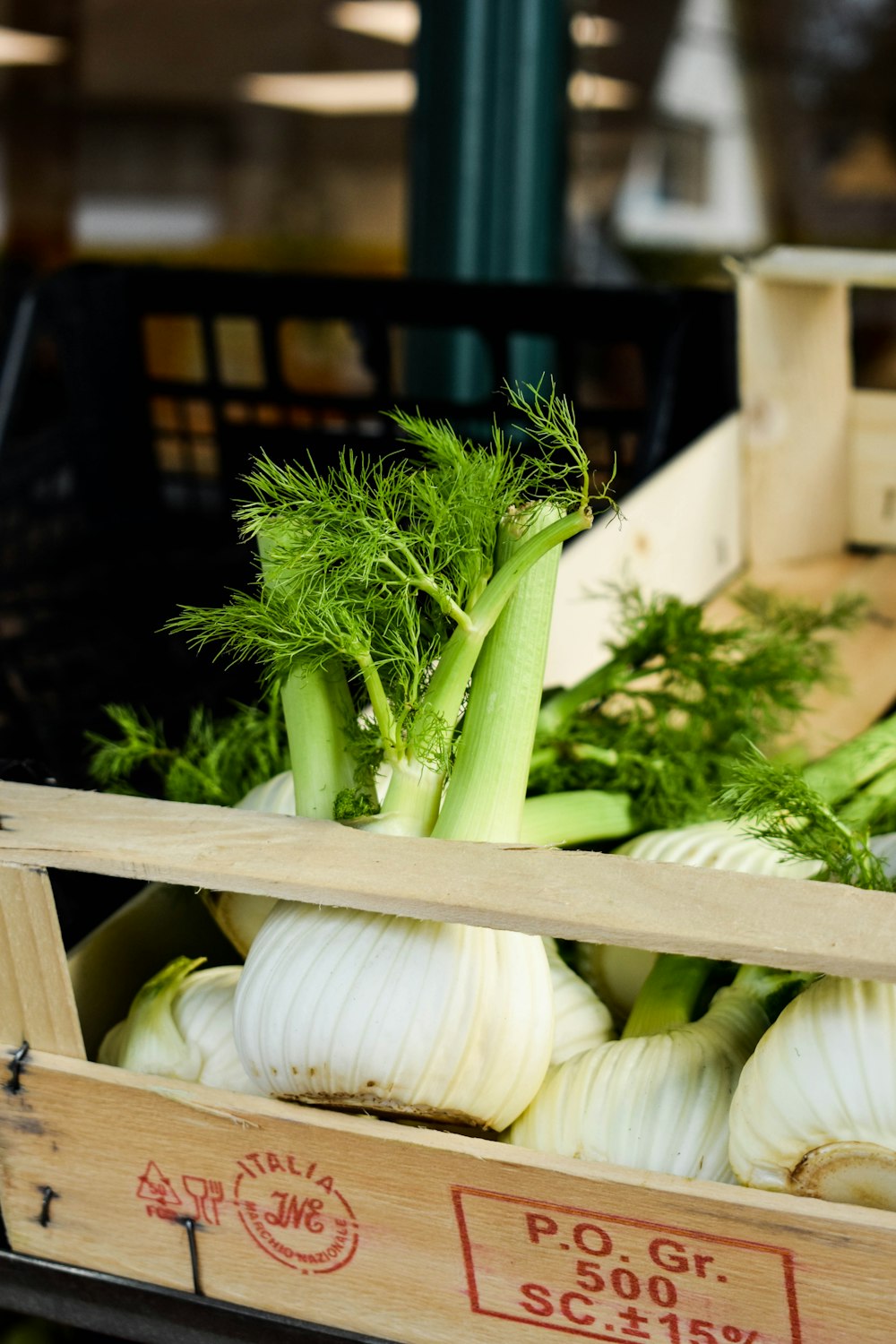 a crate filled with lots of green vegetables