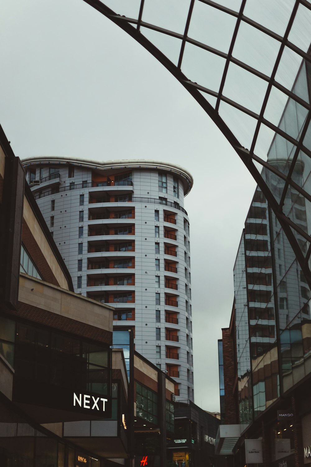 a tall white building sitting next to a traffic light