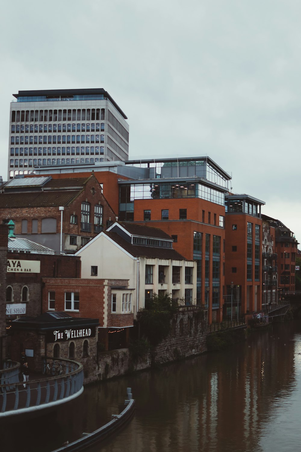 a river running through a city next to tall buildings