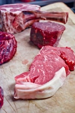 a bunch of raw meat on a cutting board