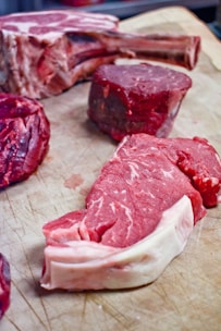 a bunch of raw meat on a cutting board