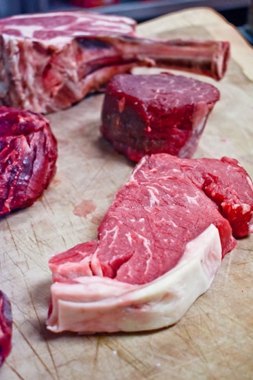 a bunch of raw meat on a cutting board
