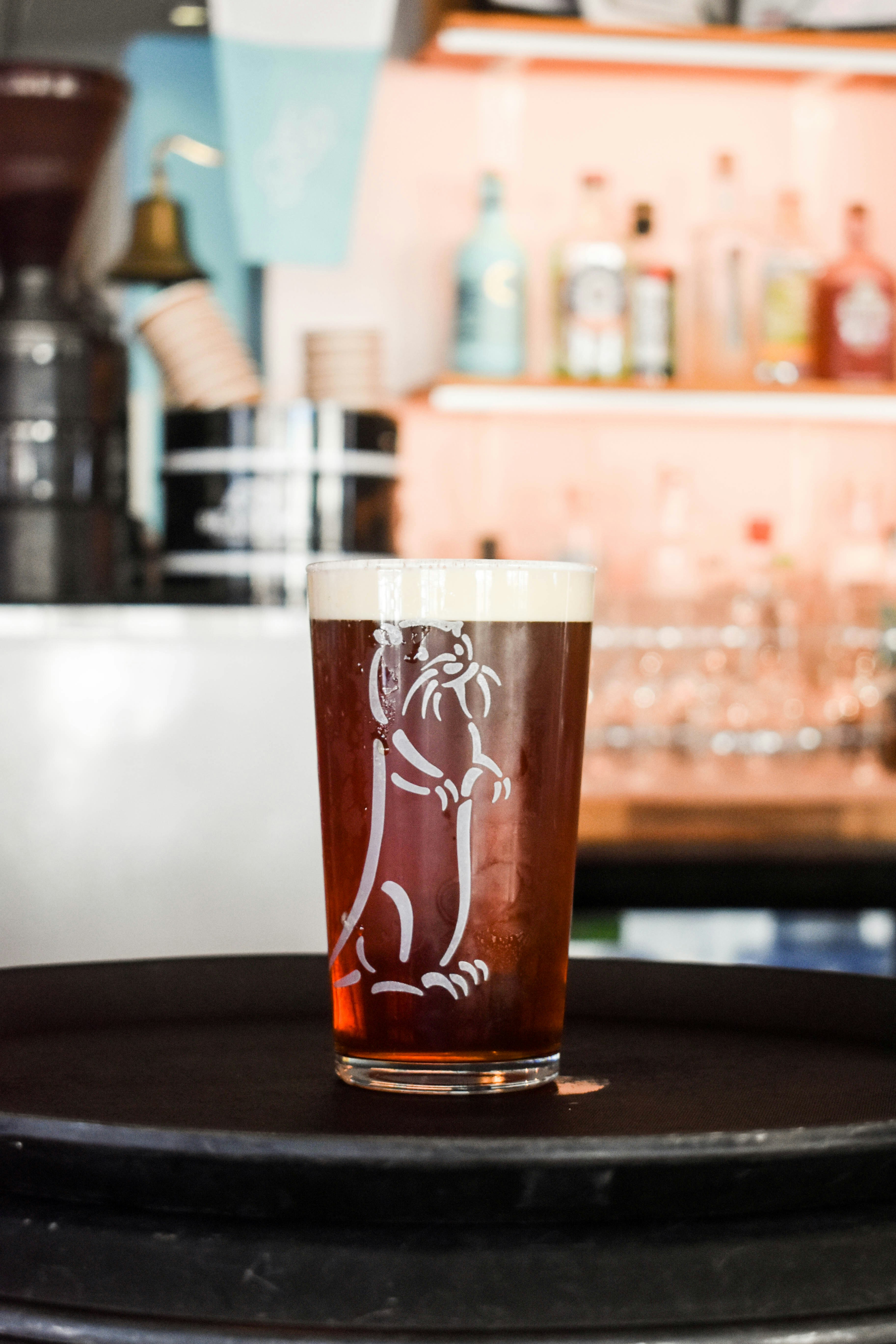 a glass of beer sitting on top of a table