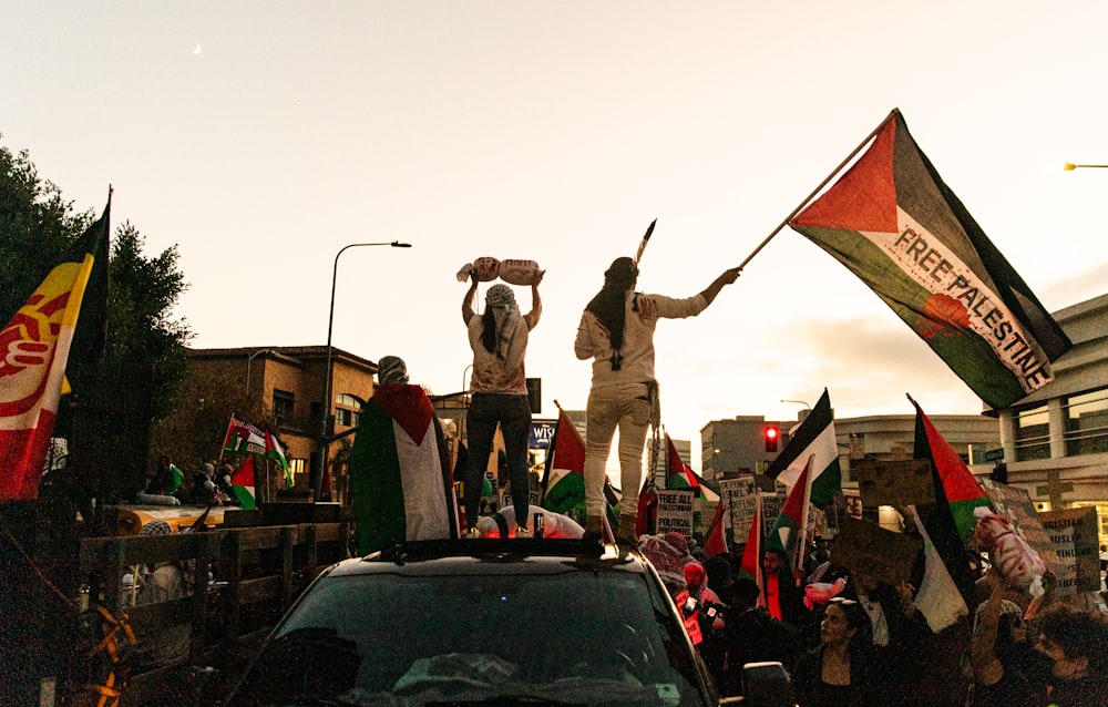 a group of people standing on top of a truck