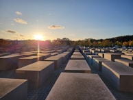 Sunset behind the veterans’ memorial, casting a warm glow over flowers and letters left by attendees.