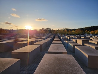 Sunset behind the veterans’ memorial, casting a warm glow over flowers and letters left by attendees.