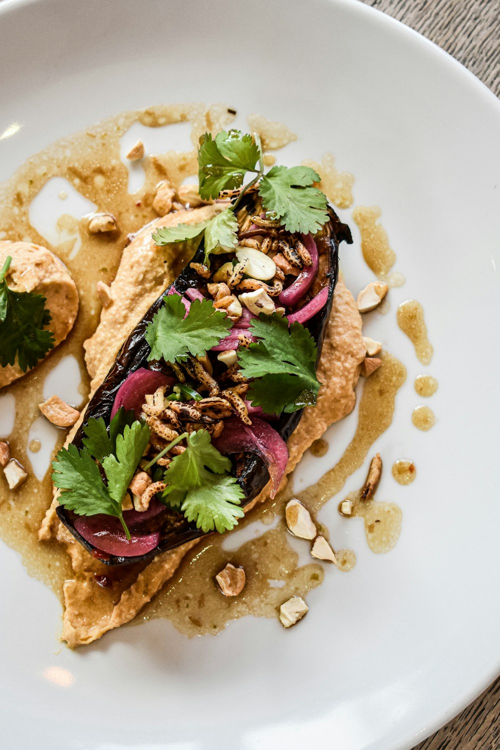 a white plate topped with an entree covered in toppings