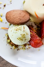 Close-up of a creamy pistachio gelato scoop with visible pistachio nuts on top in a rustic bowl.