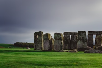 A dramatic shot of Stonehenge’s massive standing stones under a partly cloudy sky.