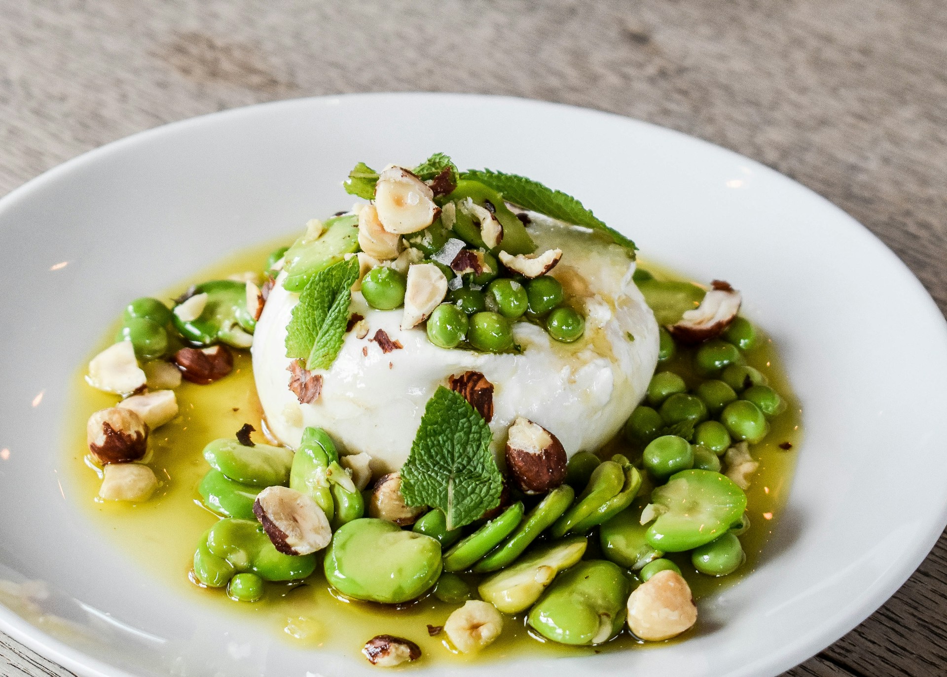 a white plate topped with a scoop of ice cream