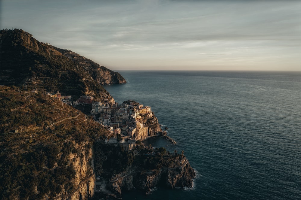 an aerial view of a village on the edge of a cliff