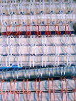 Stacked custom notebooks featuring bold, creative covers in bright hues.