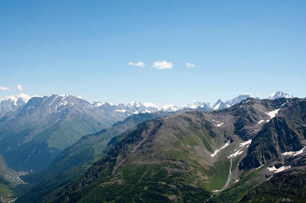 a view of a mountain range with snow capped mountains