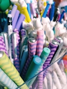 A collection of colorful gel pens arranged artistically on a wooden desk