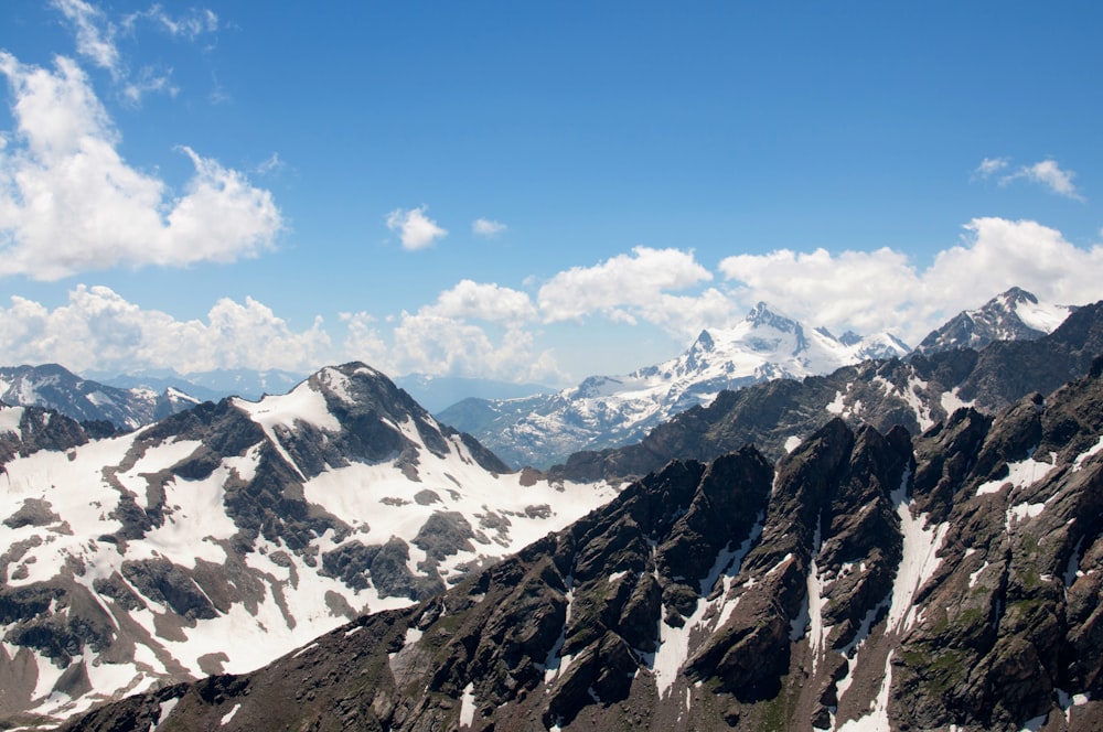 a mountain range with snow covered mountains in the background